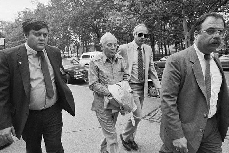 Man Escorting a Felon to Court - 20 Jun 1986, New York, New York, USA --- New York, New York:  Sixteen individuals, including the ruling hierarchy of the Gambino crime family and their associates, were indicted for involvement in racketeering (RICO) conspiracy which includes murder, loan sharking, labor payoffs, and extortion.  Being led into federal court in Brooklyn are Joseph N. Gallo (L) and Angelo Ruggiero)R), tow of the 16. --- Image by © Bettmann/CORBIS