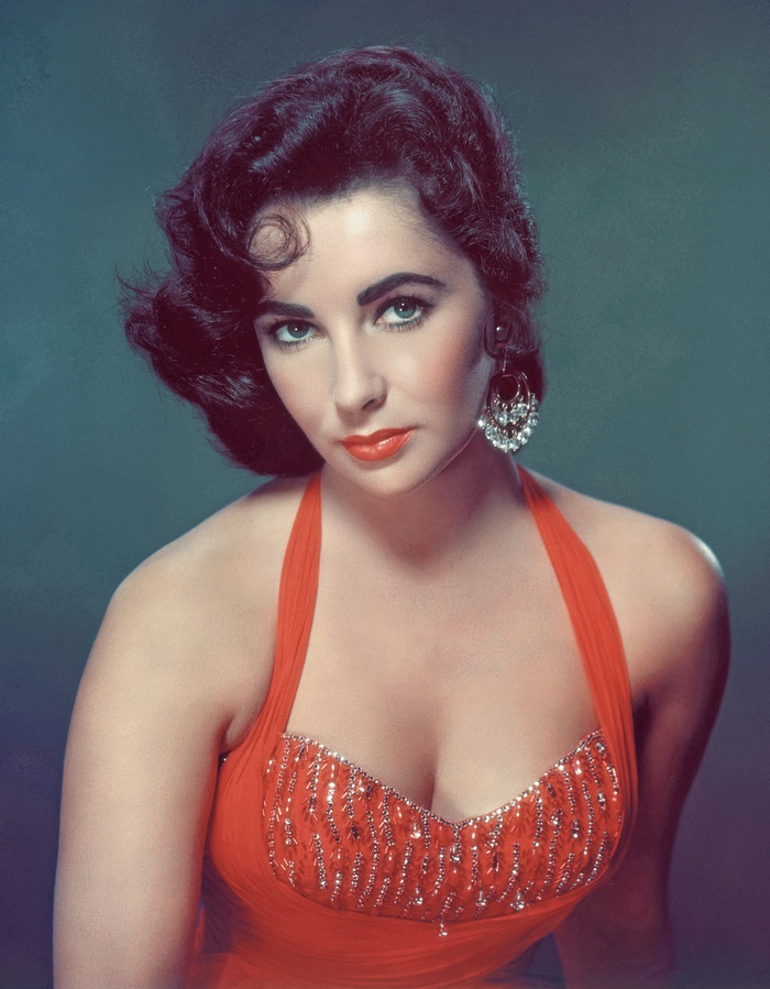 Sequinned Swimsuit - circa 1953:  British-born actress Elizabeth Taylor in a red bathing suit with sequins on the front.  (Photo by Hulton Archive/Getty Images)