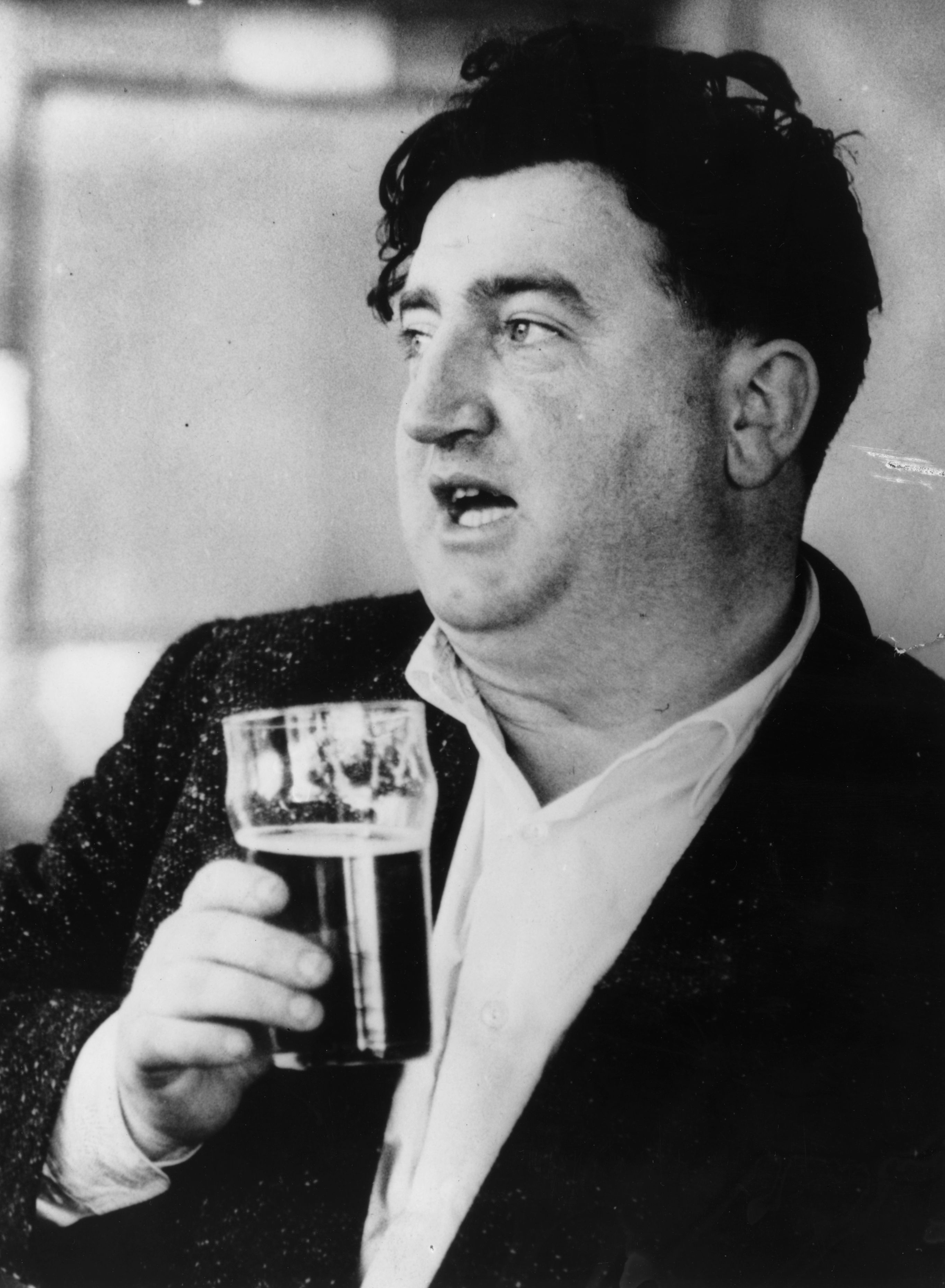 Brendan Behan - 23rd June 1956:  Irish playwright Brendan Behan (1923 - 1964) having a pint.  (Photo by Keystone/Getty Images)